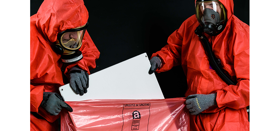 removal of asbestos by workers in safety suits